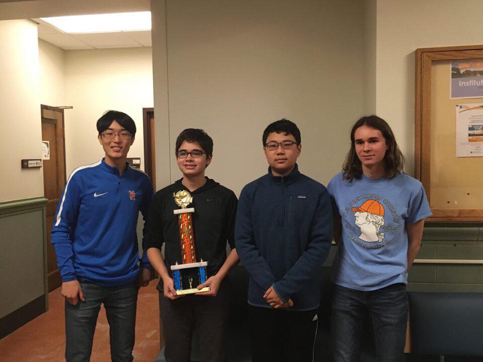The Scholastic Bowl team pose with their state championship trophy. (L-R) junior Tim Cho, sophomore Dylan Bowman, freshman Jonathan Lau, and sophomore Ethan Ashbrook. Photo courtesy of Dylan Bowman.