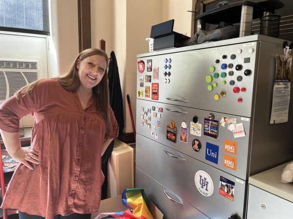 Associate Director of Student Life Hughes poses with her magnet collection.