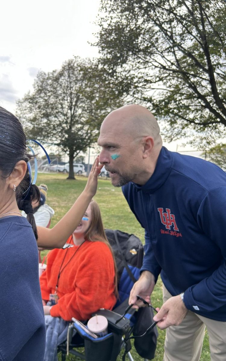 Robert Fitzgerald, Uni's Director and Principal and second-half referee, gets glitter-fied.